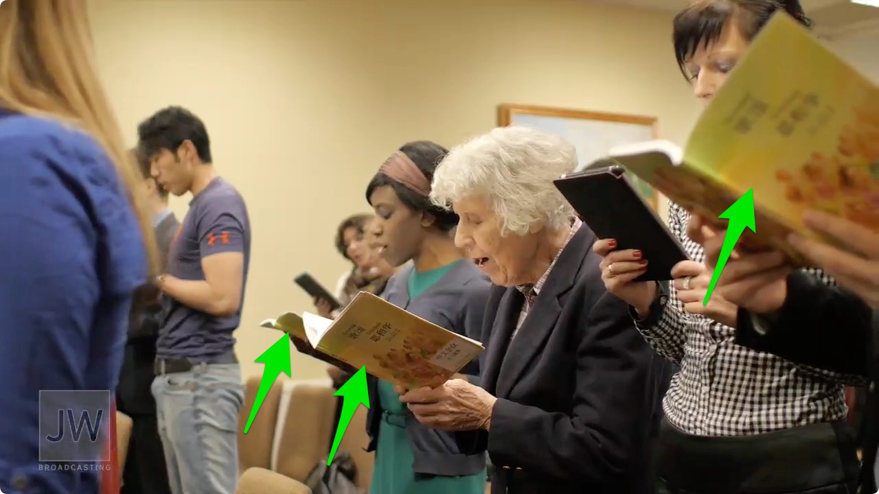 Screenshot of Sis. Margarita Königer and others using _Pīnyīn_ _Sing to Jehovah_ songbooks with musical notation